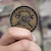 Soldier shows off coin from the Inspector General of the Army