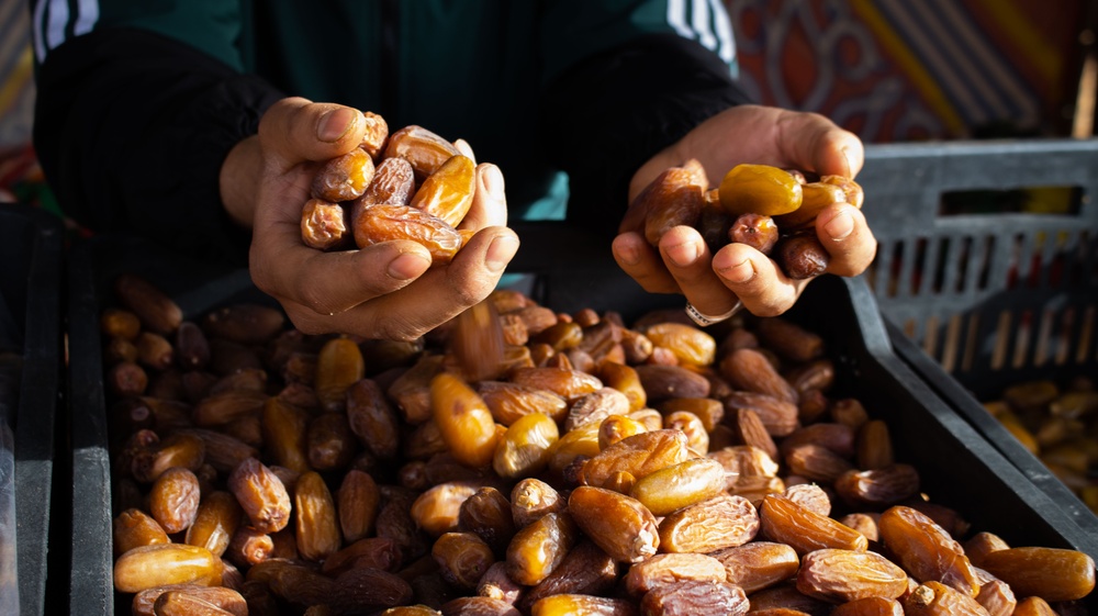 A date vendor in Sebha, Libya shows his prized dates.