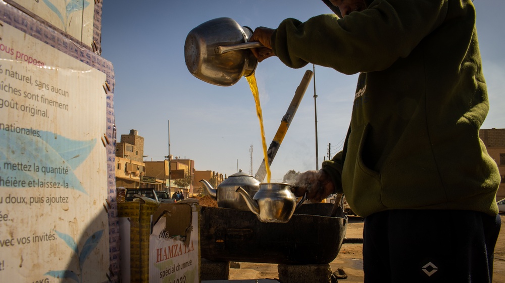 A tea vendor pours tea at his stand in Sebha, Libya