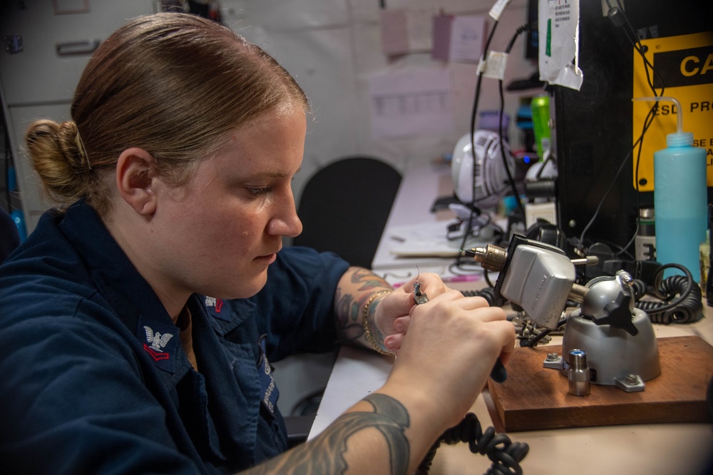 U.S. Navy Sailor Repairs Headset Cable