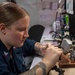 U.S. Navy Sailor Repairs Headset Cable