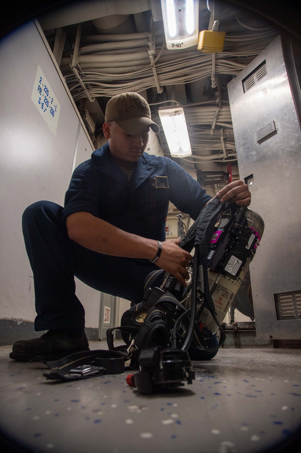 U.S. Navy Sailor Checks Fire Fighting Equipment