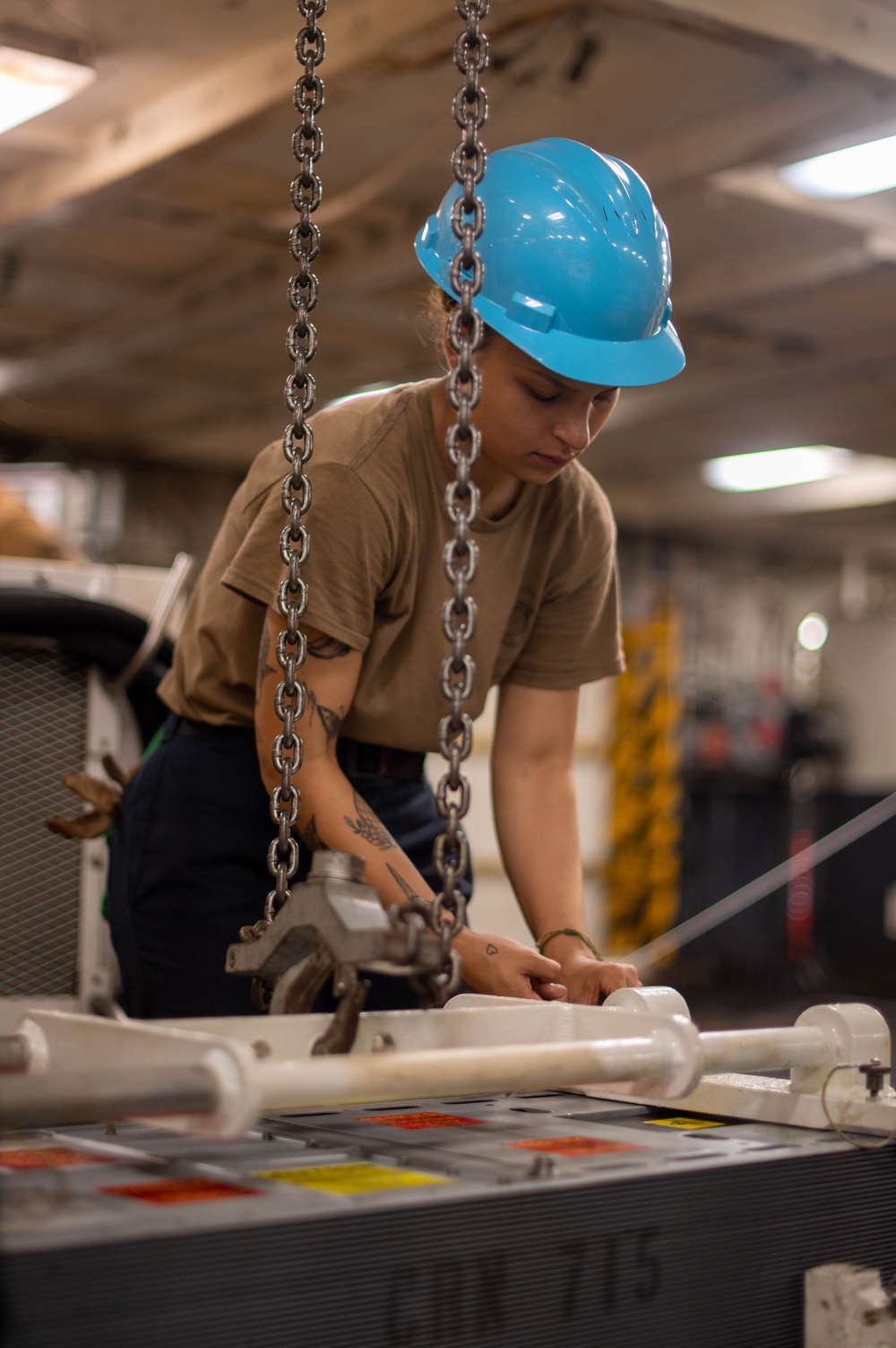 U.S. Navy Sailor Prepares To Hoist A Transmitter