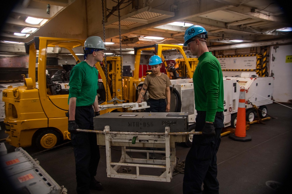 U.S. Navy Sailors Move An Aircraft Transmitter