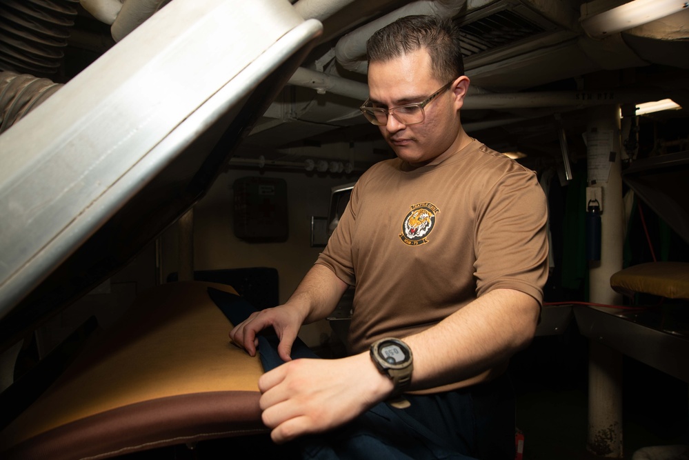 Sailor Prepares To Hot Press Coveralls