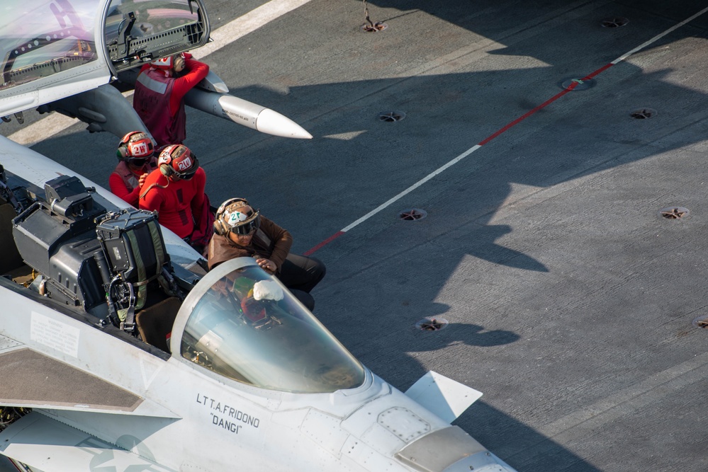 Sailor Cleans The Canopy Of A Super Hornet