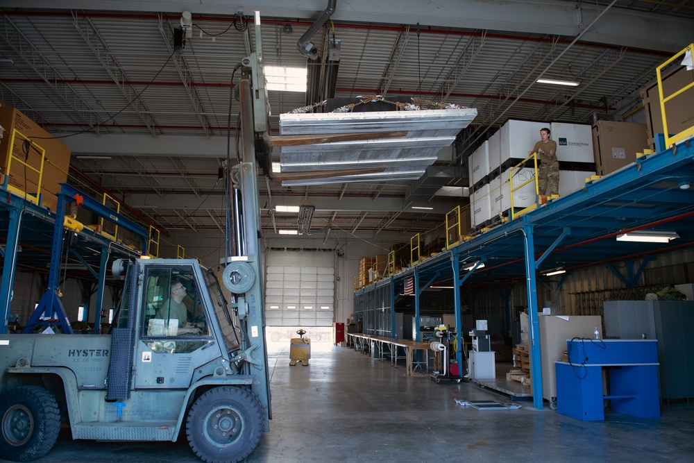 Aerial Port Airmen move equipment with forklift