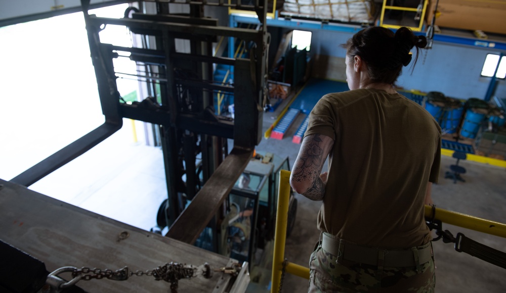 Aerial Port Airmen move equipment with forklift