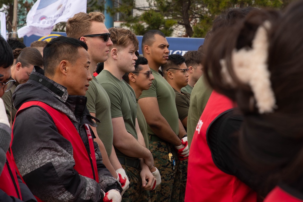 HQ Bn. Marines clean the beach