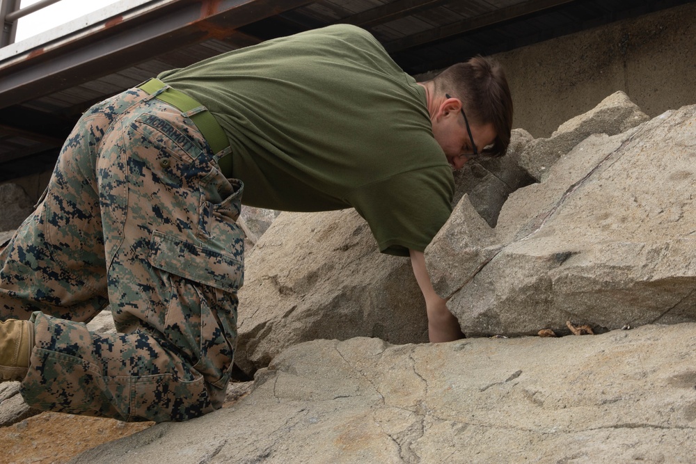 HQ Bn. Marines clean the beach