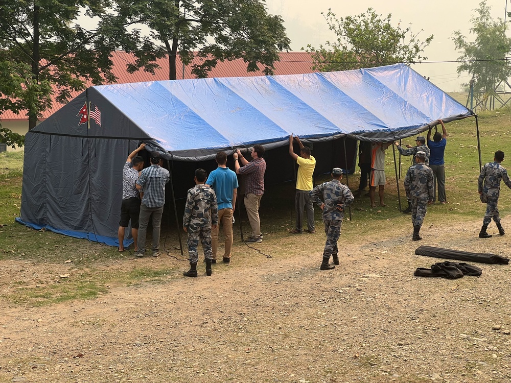 Nepal Armed Police Force (APF) members are setting up for a simulated mass casualty trauma lane at the APF Disaster Management Training School