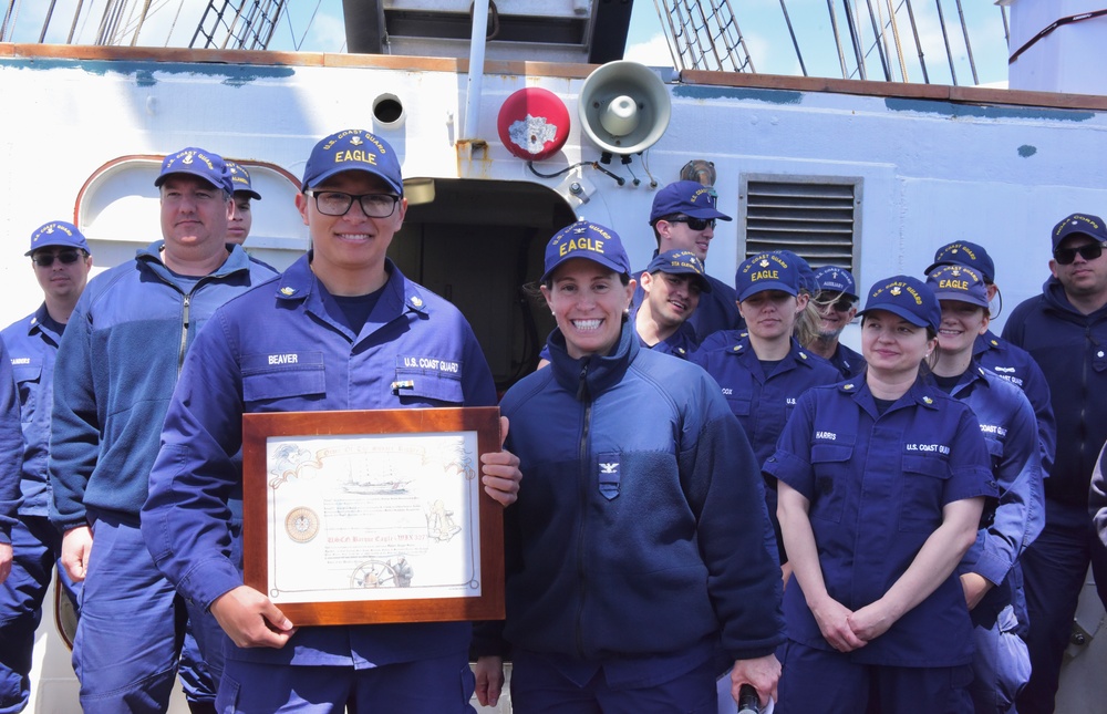 USCGC Eagle crew member awarded ribbon and plaque while underway in the Atlantic Ocean