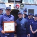 USCGC Eagle crew member awarded ribbon and plaque while underway in the Atlantic Ocean