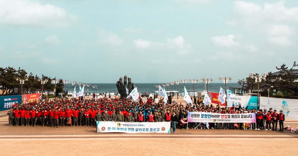 US Marines, Republic of Korea Marines and Sailors, and local community volunteers help clean the earth