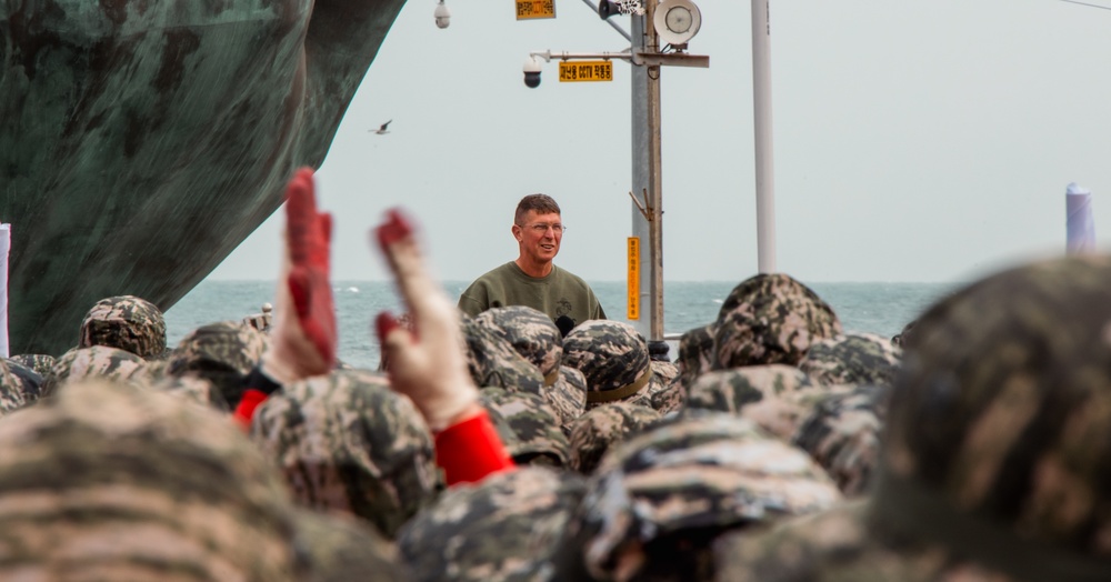 US Marines, Republic of Korea Marines and Sailors, and local community volunteers help clean the earth