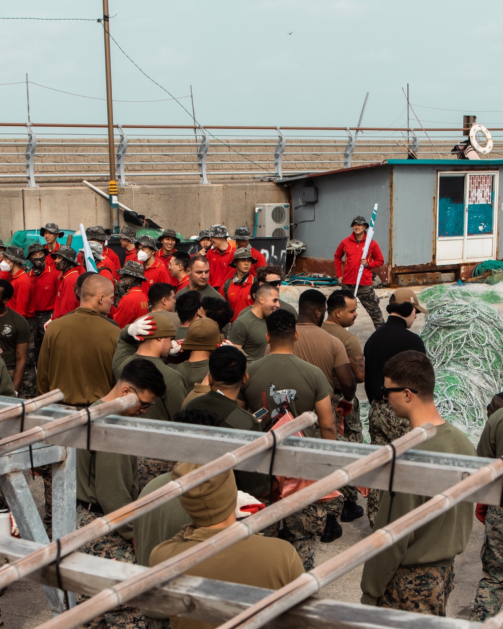 US Marines, Republic of Korea Marines and Sailors, and local community volunteers help clean the earth