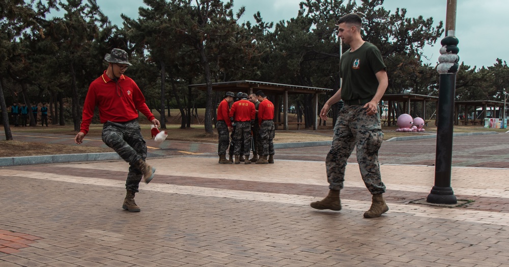 US Marines, Republic of Korea Marines and Sailors, and local community volunteers help clean the earth