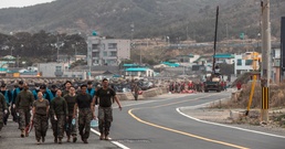 US Marines, Republic of Korea Marines and Sailors, and local community volunteers help clean the earth