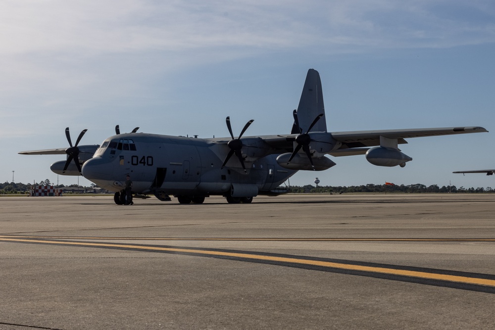 U.S. Marines with VMGR-252 load cargo into a KC-130J Hercules during Emerald Warrior 23 FTX