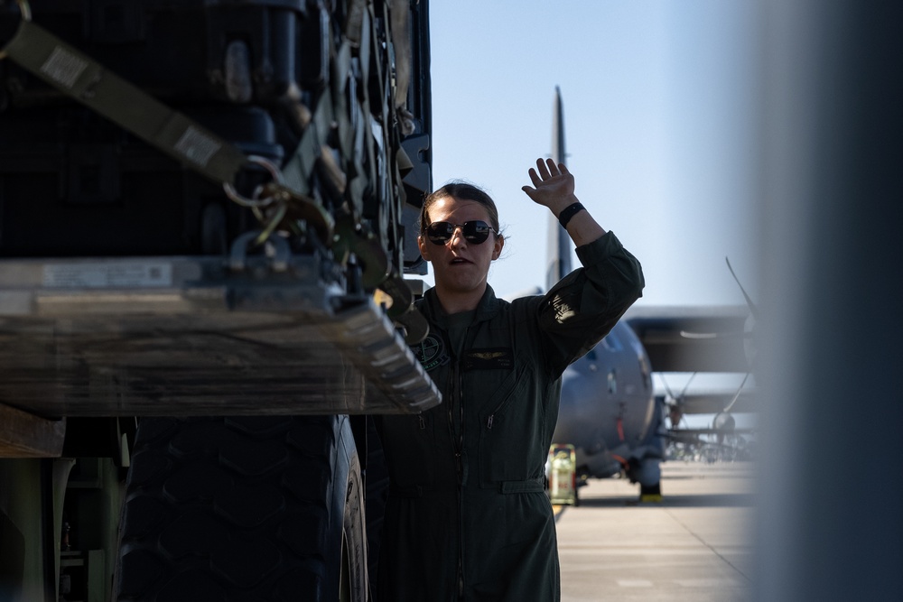 U.S. Marines with VMGR-252 load cargo into a KC-130J Hercules during Emerald Warrior 23 FTX