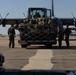 U.S. Marines with VMGR-252 load cargo into a KC-130J Hercules during Emerald Warrior 23 FTX