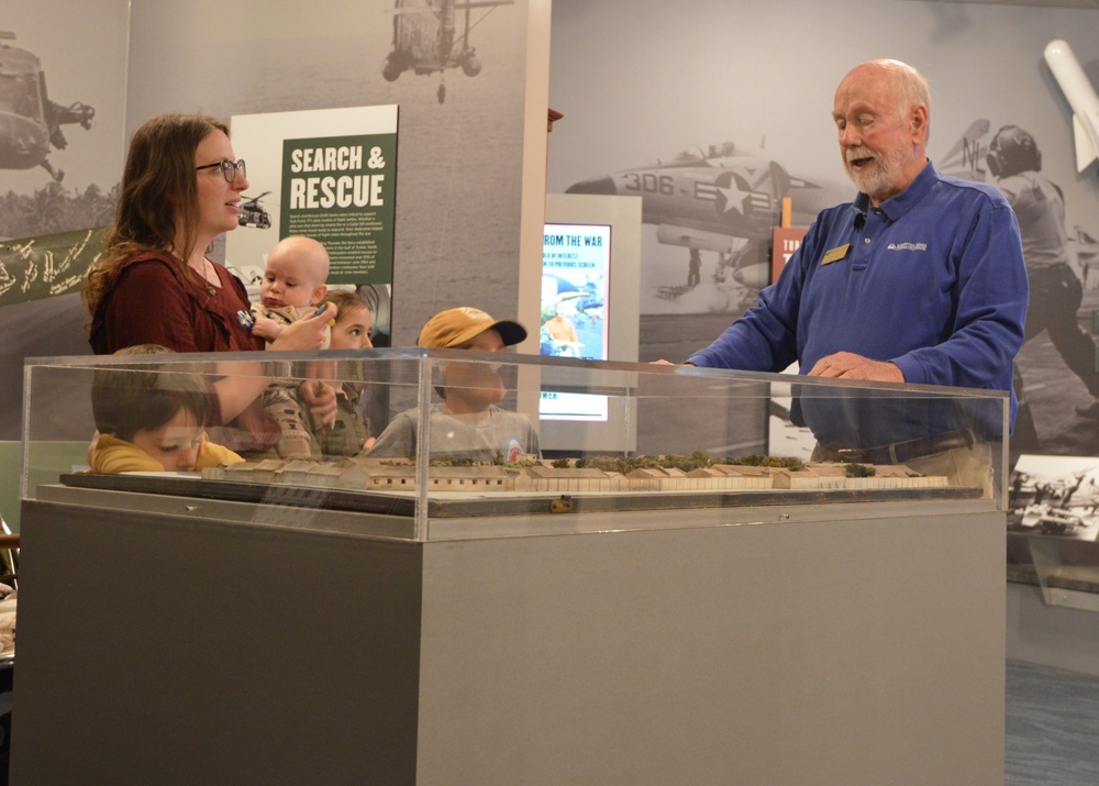 Museum volunteer engages with visitors