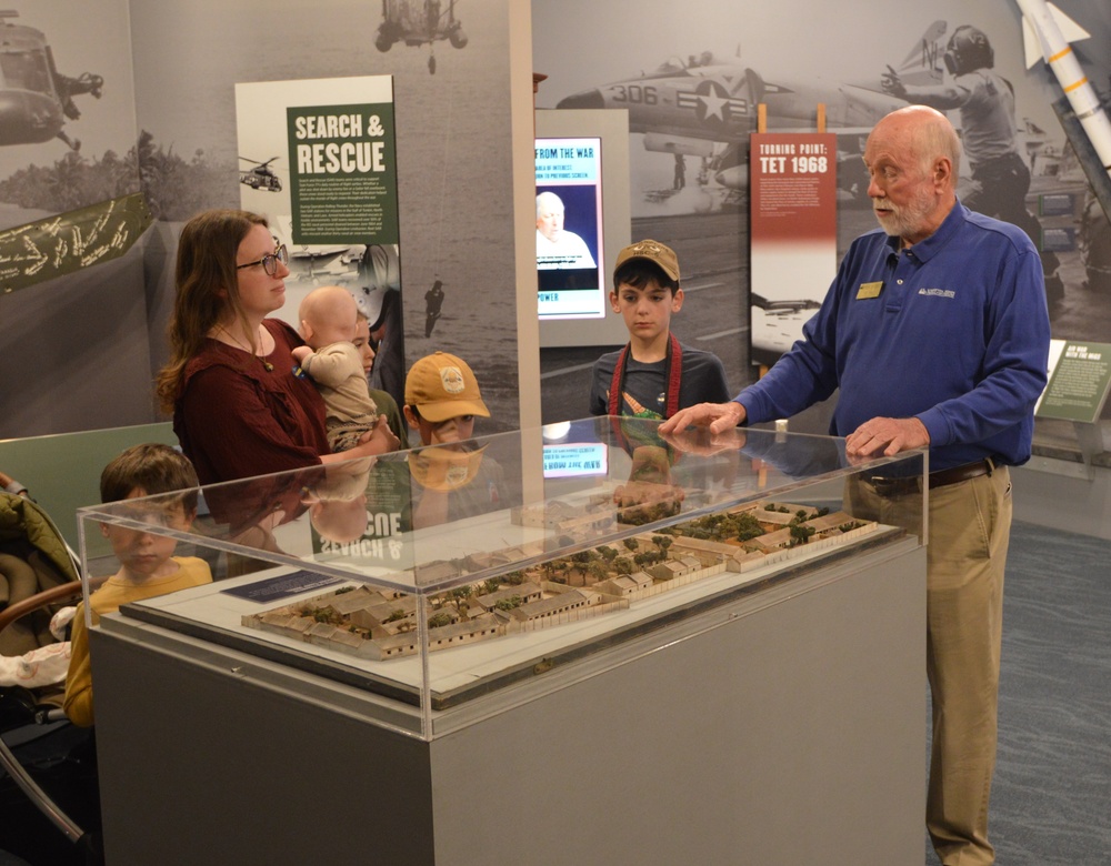 Museum volunteer docent engages with visitors