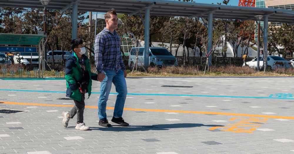 US Marines and children with the Pohong Dasom Children's Center tour Pohong