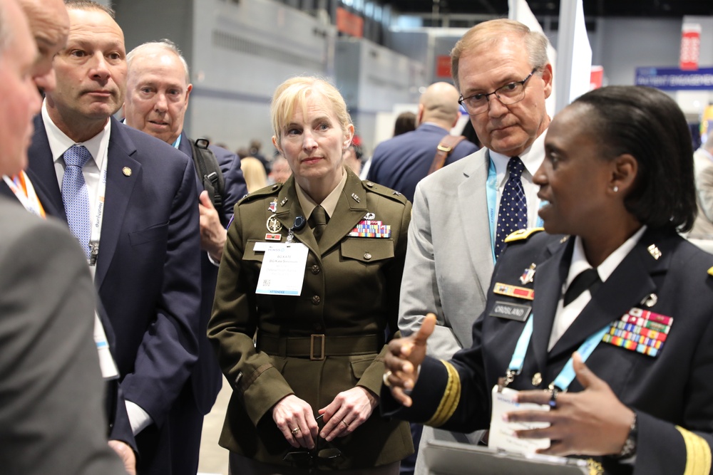 Lt. Gen. Crosland, Brig. Gen. Simonson, and Pat Flanders tour the Federal Health Pavilion at the HIMSS Conference