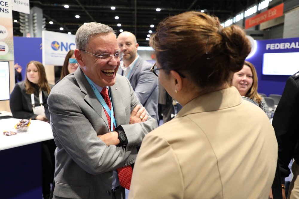 Dr. Lester Martinez-Lopez, Assistant Secretary of Defense for Health Affairs, shares a laugh at the HIMSS Conference