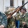 A U.S. Army Soldier aims down the sights of a replica rifle with Bulgarian volunteer