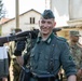 A Bulgarian volunteer carries weapon after WWII reenactment