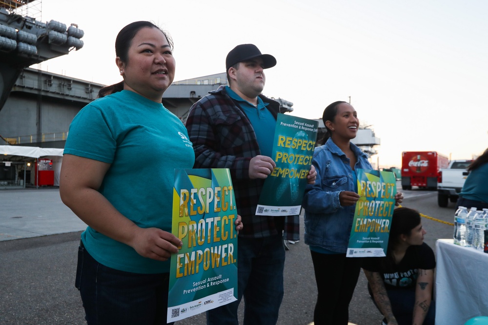 USS Abraham Lincoln SAPR VA team members promote sexual assault awareness