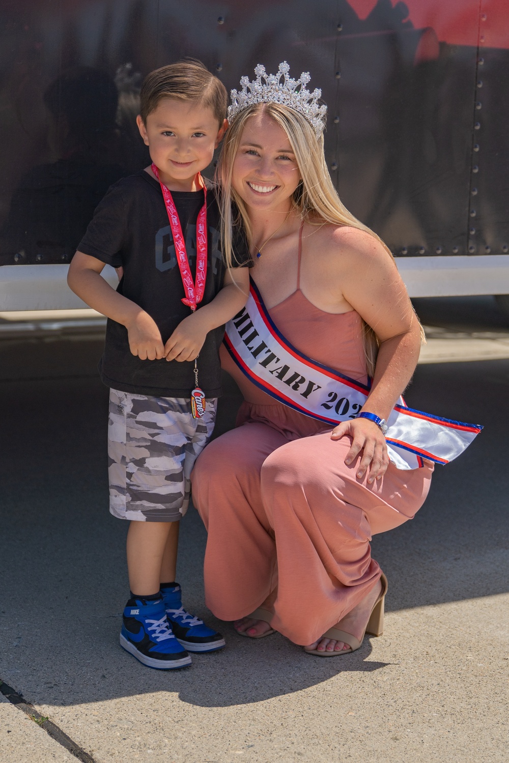 Ms. Military 2023 takes snapshot with a young visitor at the SoCal Air Show