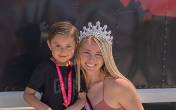 Ms. Military 2023 takes snapshot with a young visitor at the SoCal Air Show