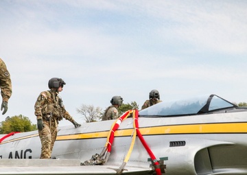 Iowa Chinook crew attach straps to F-80 Shooting Star for sling load