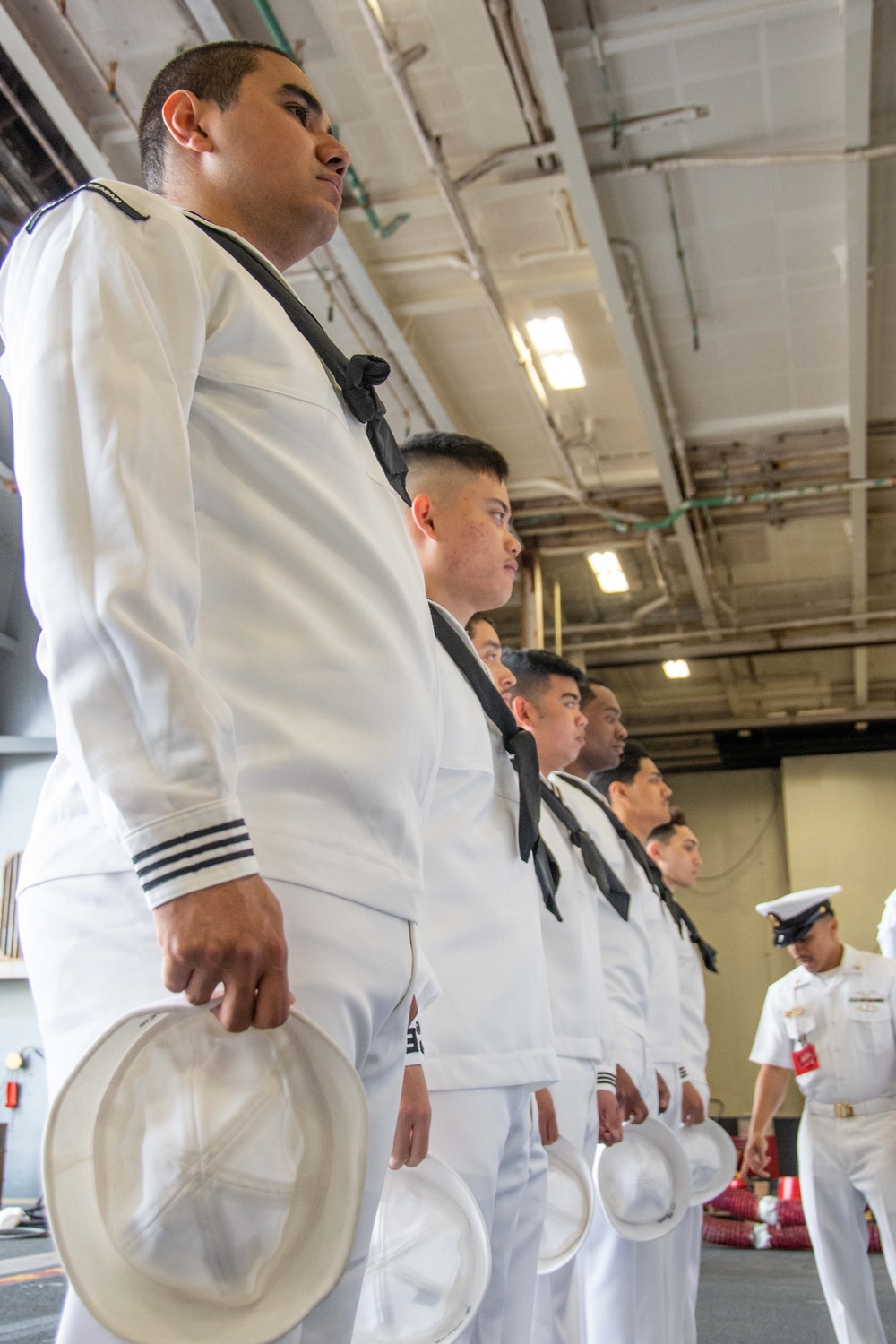 USS Ronald Reagan (CVN 76) Sailors conduct dress whites uniform inspection