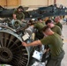 Ace of Spades maintainers work on a Harrier II jet engine