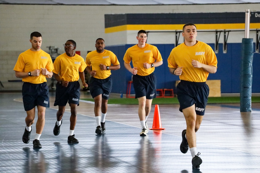 Recruits run in Freedom Hall at Recruit Training Command