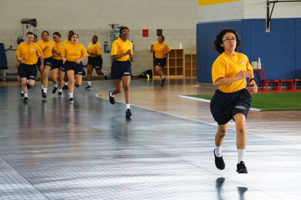 Recruits run in Freedom Hall at Recruit Training Command
