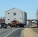 Contractors move fourth World War II-era barracks to new location in April 2023