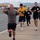 Service members and civilians participate in a SAPR Awareness 5K run