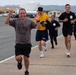 Service members and civilians participate in a SAPR Awareness 5K run