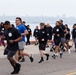 Service members and civilians participate in a SAPR Awareness 5K run