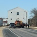 Contractors move fourth World War II-era barracks to new location in April 2023