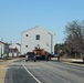 Contractors move fourth World War II-era barracks to new location in April 2023