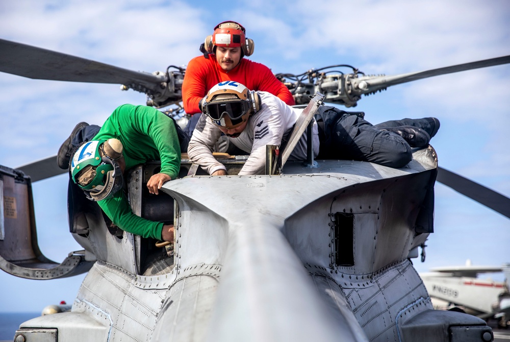 Sailors work on flight deck