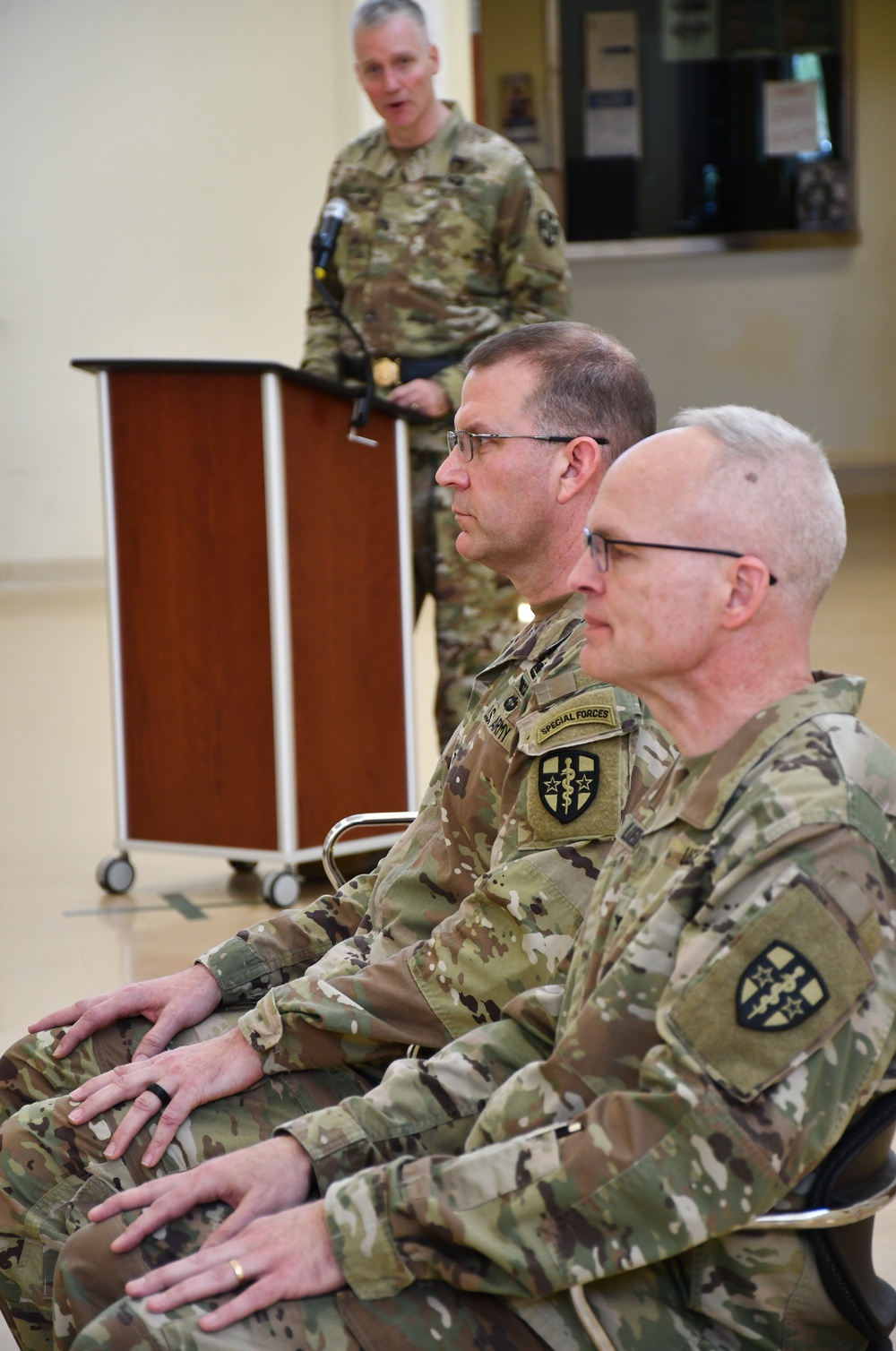 Collard presents remarks as Luedeman and Jackson listen on