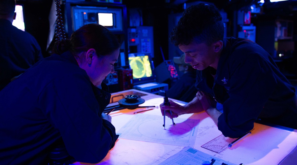 Sailors aboard U.S. 7th Fleet Flagship USS Blue Ridge (LCC 19) stand watch in the combat information center.