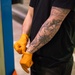 914th vehicle maintenance Airman puts on gloves before oil change